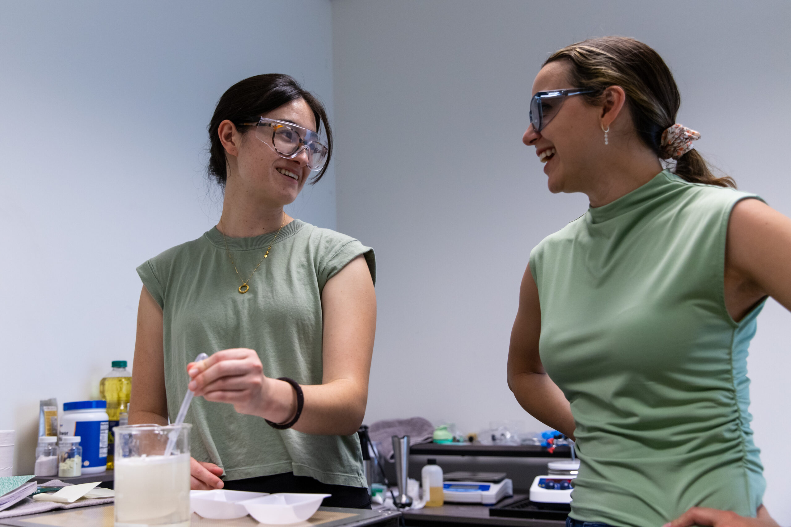 Michelle Cullen and Mayela Fernandez experimenting with a sargassum-based coating solution in an EcoPlasticity laboratory.