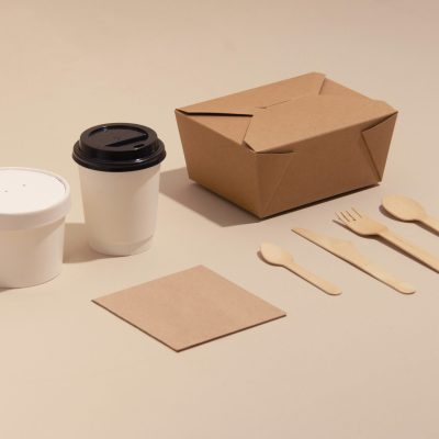 Compostable food packaging products including paper cups, takeout containers, napkins, and wooden utensils coated with EcoPlasticity technology.